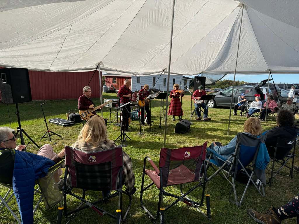 Local bluegrass band Borrowed Thyme playing music outside the Oxbow Community Center.