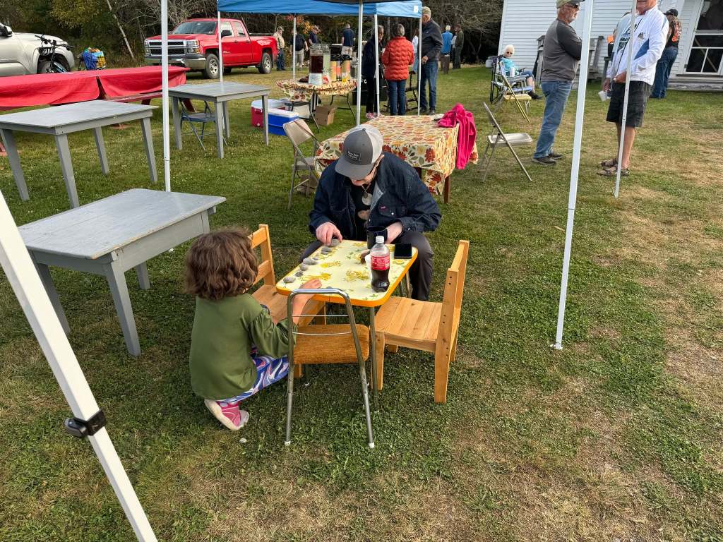 Community members having a snack outside the Oxbow Community Center.